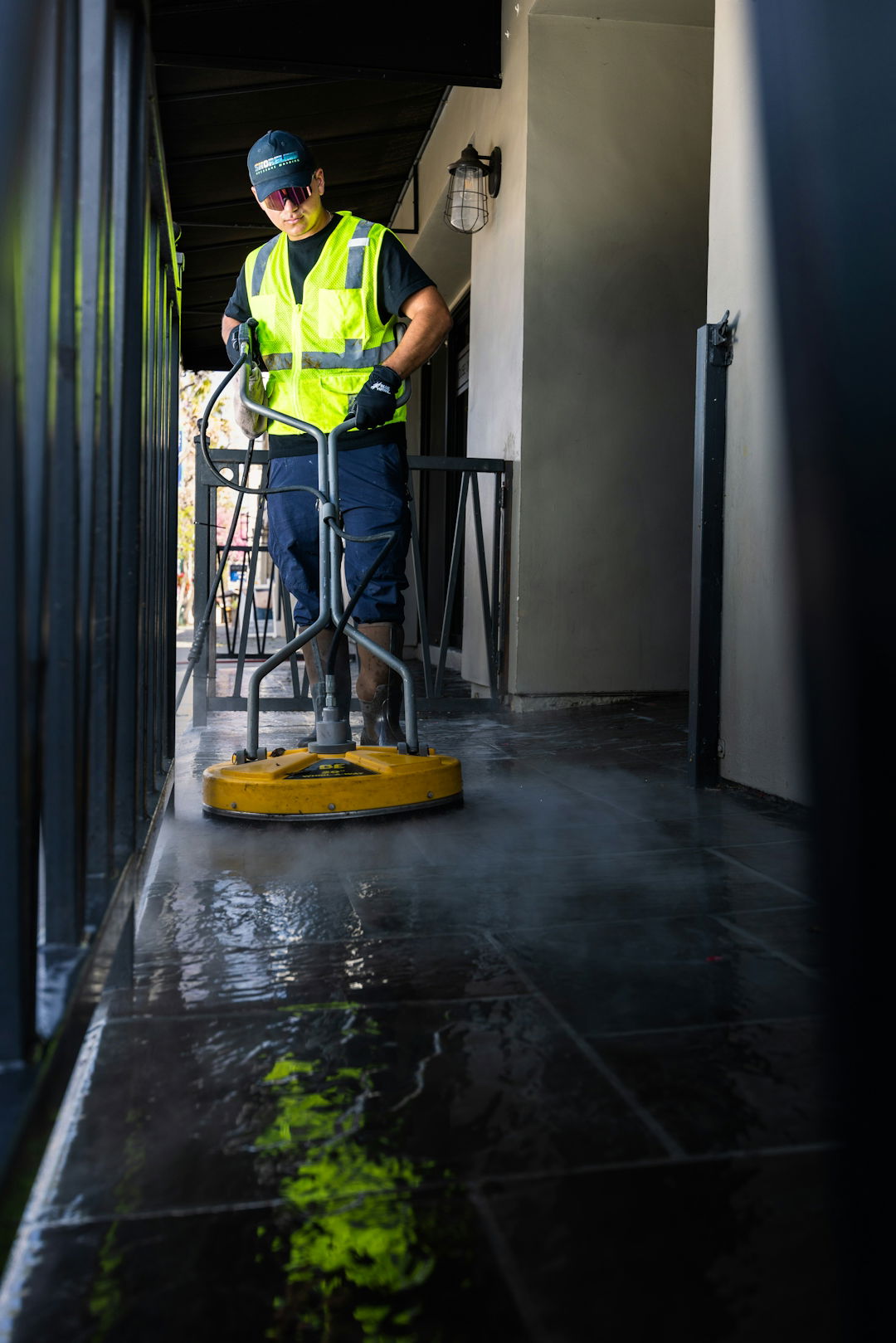 a-man-in-a-yellow-vest-is-cleaning-the-floor.jpg a man in a yellow vest is cleaning the floor